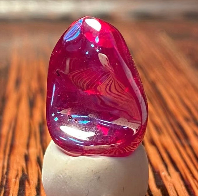 a ruby on top of a white stone